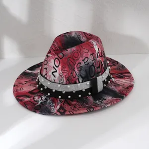 Detailed view of red graffiti print fedora hat with elegant pearl and rhinestone bands