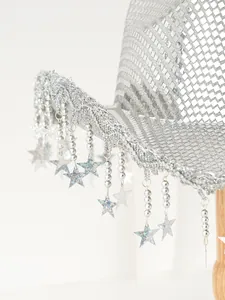 Close-up of silver sequin cowboy hat with glittering star tassels and fringe detail