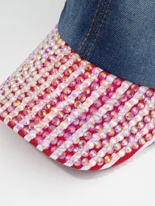 Close-up of sparkling iridescent rhinestones on a heavy-duty denim baseball cap