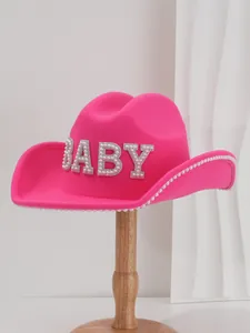 Detail of pink wool felt cowboy hat with rhinestone 'BABY' lettering and pearl trim.