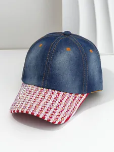 Close-up detail of a blue denim baseball cap featuring a shiny iridescent rhinestone brim