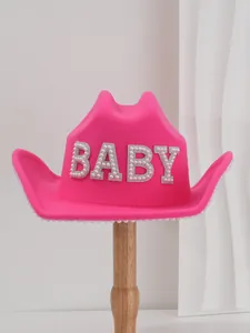 Close-up of hot pink felt cowboy hat featuring elegant pearl BABY lettering
