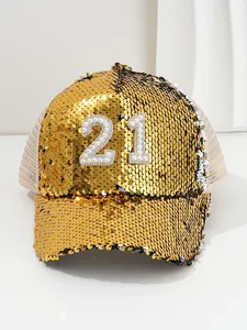 Detailed view of a gold sequin baseball cap featuring a pearl and rhinestone number 21