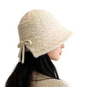 Elegant hand-knitted bucket hat for women featuring a side bow design in cream white finish