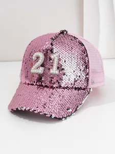 Close-up detail of a pink sequin baseball cap featuring a pearl and rhinestone 21.