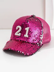 Detail view of a bright pink sequin baseball cap featuring pearl number 21 design