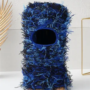 Macro detail of the distressed fuzzy knit texture on blue camouflage ski mask balaclava