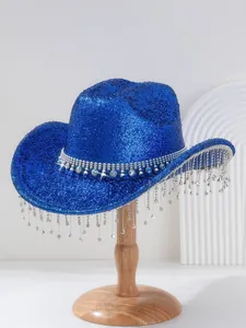 Sparkly blue cowboy hat with rhinestone fringe on wooden stand