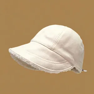 Side view detail of a beige corduroy potted hat featuring thick warm lamb wool lining