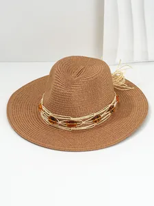 Close-up detail of brown Panama straw hat featuring amber gemstones and woven band