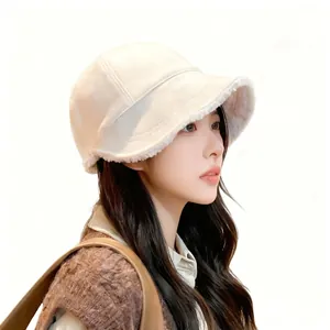 Close-up of a stylish cream lamb wool bucket hat with warm fleece lining and short brim