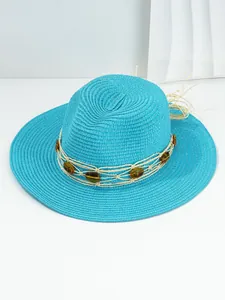 Detailed view of turquoise Panama straw sun hat with amber-colored resin beads