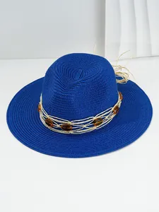 Detailed view of a blue woven straw sun hat featuring elegant amber stone embellishments.