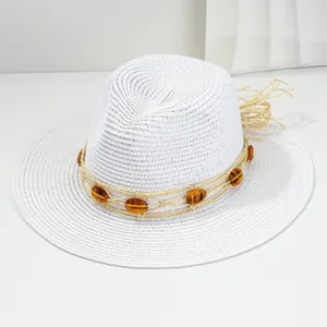 White woven Panama straw hat with amber bead decoration for beach and sun protection