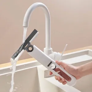 Handheld mini self-squeezing sponge mop being rinsed under a water faucet in a sink