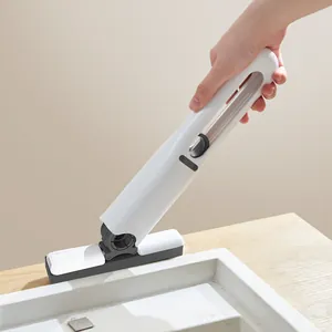 Macro view of a portable mini handheld sponge mop cleaning a white sink surface