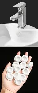 White silicone washbasin overflow hole plug shown installed and in a hand for detail.