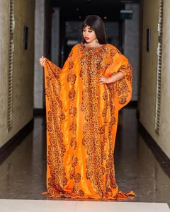 Elegant African orange chiffon maxi dress with floral patterns and hot-fix rhinestones.