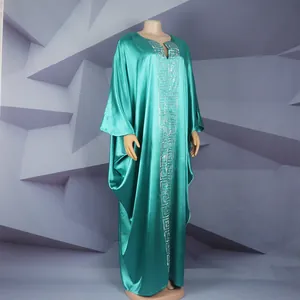 Full-length view of a teal satin African kaftan dress with silver Greek key pattern.