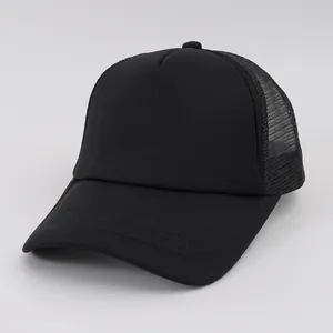 Macro view showing the mesh and foam structure of a classic solid black trucker cap