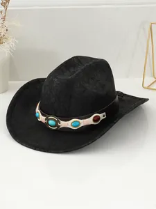 Macro view of vintage black cowboy hat with turquoise gemstone and rivet belt decoration