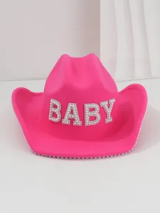 Detailed shot of hot pink felt cowboy hat with BABY pearl and rhinestone letters.