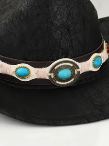 Detail of vintage cowboy hat belt with turquoise stones and gold rivets.