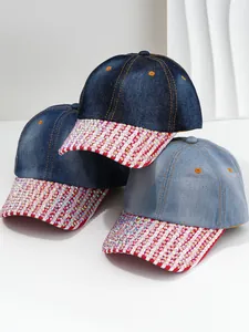 Close-up of sparkling rhinestone-embellished brims on versatile denim baseball caps