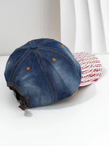 Back and side view of a blue denim baseball cap featuring a sparkling rhinestone brim detail