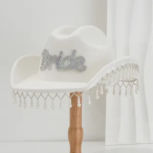 White wool cowboy hat with Bride rhinestone patch and pearl fringe for wedding party.