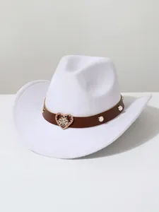 Detailed view of a white wool cowboy hat featuring a crystal heart and pearl band.