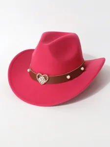 Close-up detail of hot pink woolen cowboy hat with elegant heart rhinestone and pearl band