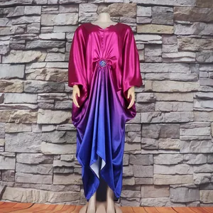 Detail of an African Bubu dress in magenta to blue gradient with rhinestone waist.