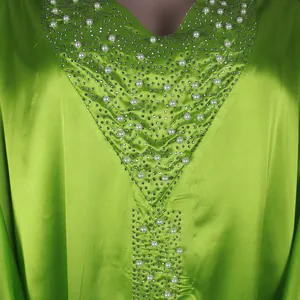 Detailed macro view of V-neckline on a lime green African Bubu robe with pearls