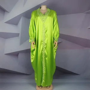 Full length view of a bright green African Bubu gown with rhinestone and pearl details.