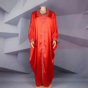 Detailed view of red African Bubu dress with V-neck rhinestones and batwing sleeves