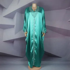 Detail view of teal satin African BUBU gown featuring intricate beadwork and V-neck.