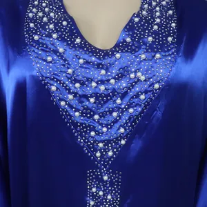 Detail view of blue African BUBU robe neckline with rhinestones and white pearls