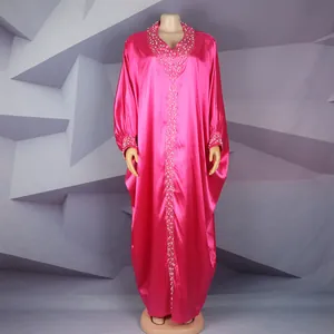 Close-up of bright pink African bubu dress with rhinestone and bead neck detail