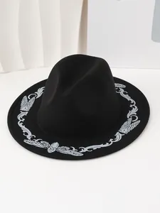 Close-up of black Western fedora hat with silver butterfly embroidery on the brim.