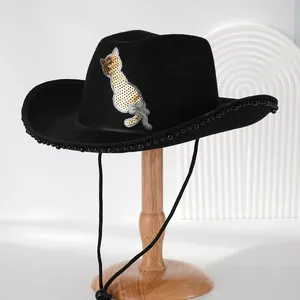 Detailed view of a stylish black cowboy hat with a gold sequin cat patch and pearl trim