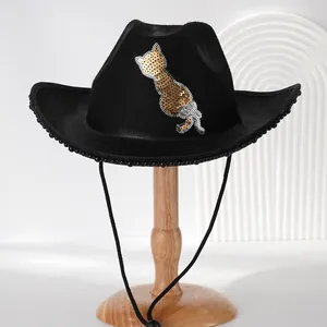 Detailed view of a black cowboy hat with gold sequin cat and bead trim decoration.