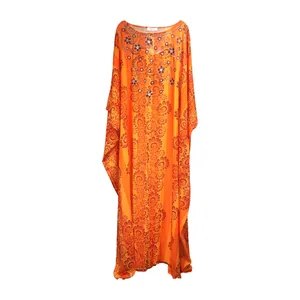 Detail of vibrant orange African chiffon dress with beaded rhinestones and floral motifs