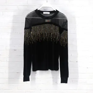 Detail showing the intricate gold rhinestone vertical stripes on black velvet top.