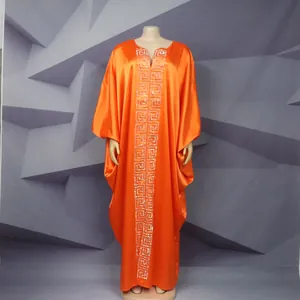 Detail view of bright orange African kaftan maxi dress with silver Greek key embroidery
