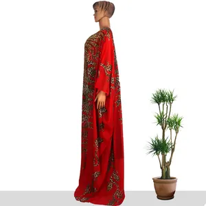 Side view of red African chiffon kaftan with leopard print and gold rhinestones.