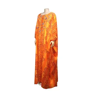 Close-up of African chiffon kaftan dress featuring orange floral patterns and beads