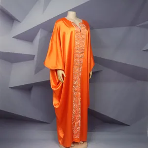 Detail of orange satin African plus size loose long dress with Greek key pattern.