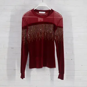Detailed view of burgundy velvet top with mesh yoke and rhinestone fringe decoration