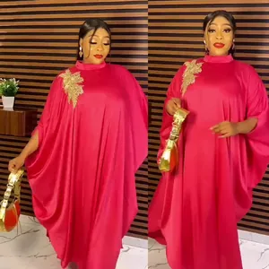 Elegant fuchsia African kaftan dress with gold lace applique and batwing sleeves.